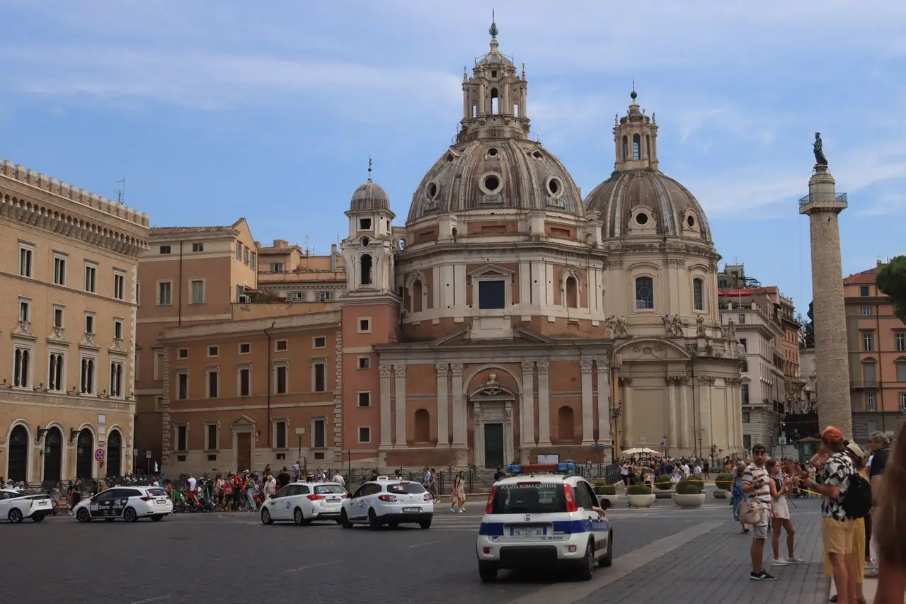 Historic architecture and lively city square with Trajans Column in Rome, Italy.